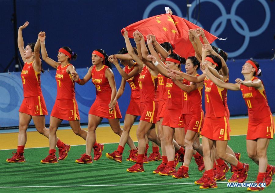 Members of the women\'s hockey team of China celebrate after winning the silver medal at the Olympic Games in Beijing, capital of China, Aug. 22, 2008. This year marks the 70th anniversary of the founding of the People\'s Republic of China (PRC). On April 5, 1959, Rong Guotuan won the champion of the men\'s singles event at the 25th ITTF World Table Tennis Championships in Dortmund, Germany, becoming China\'s first ever world champion. Chinese players have made more achievements during the 60 years since then. (Xinhua/Yang Lei)