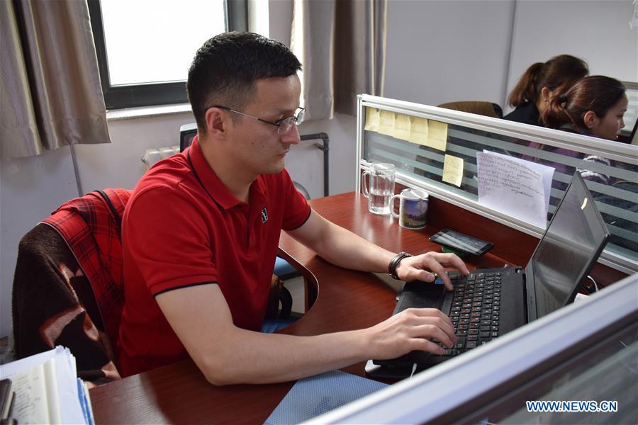 Sadyrbek, a Kyrgyz PhD candidate studying in China, revises his doctoral dissertation at the office of Xinjiang Institute of Ecology and Geography of Chinese Academy of Sciences in Urumqi, northwest China\'s Xinjiang Uygur Autonomous Region, June 11, 2019. (Xinhua/Bai Jiali)