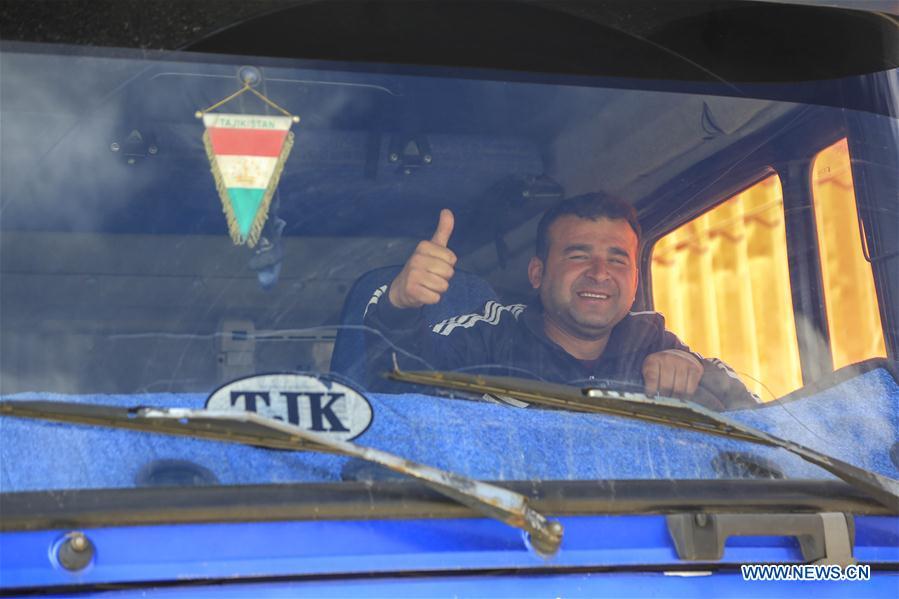 A driver from Tajikistan thumbs up to greet in Karasu port, northwest China\'s Xinjiang Uygur Autonomous Region, June 11, 2019. With the Belt and Road Initiative, the trade between Xinjiang, Kyrgyzstan and Tajikistan has continued to develop. On the southern border of Xinjiang, three ports, Turugart, Erkeshtam and Karasu, between China and Kyrgyzstan and Tajikistan, saw large quantities of goods cleared by customs every year. (Xinhua/Huang Huan)