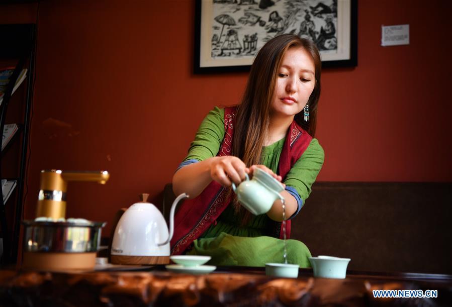 Takyrbasheva Asel, a student from Kyrgyzstan, performs tea art at a teahouse in Hainan University in Haikou, south China\'s Hainan Province, June 13, 2019. Kyrgyz girl Takyrbasheva Asel majors in Tourism Management in Hainan University. She has dedicated herself in experiencing the Chinese culture, including the learning of traditional Chinese musical instruments, Taiji and martial arts, and tea art since she came to China three years ago. She hoped she could stay in China after graducation and invite people from her hometown to come and experience the Chinese culture. Statistics showed that over 4,600 Kyrgyz students studied in China in 2018. (Xinhua/Guo Cheng)