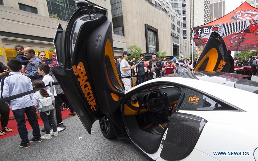 People visit the 2019 Yorkville Exotic Car Show in Toronto, Canada, June 16, 2019. More than 110 classic and exotic cars were displayed at the annual Father\'s Day event on Sunday, attracting tens of thousands of visitors. (Xinhua/Zou Zheng)
