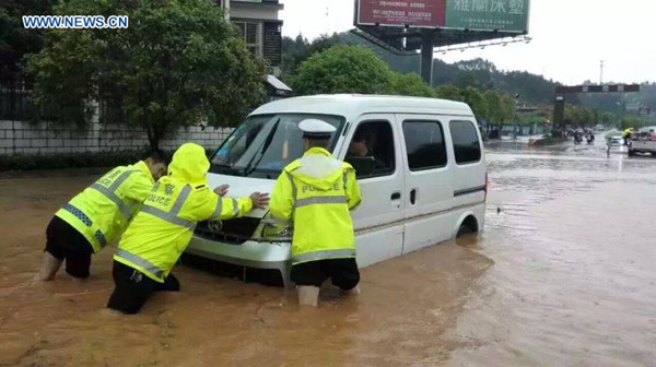 Policemen push a trapped car at the Mingyueshan scenic spot in Yichun, east China's Jiangxi Province, May 6, 2016. Mountain torrents hit the scenic zone and Wentang Town on the foot of the hill at about 11:00 a.m. Friday, causing dozens of people trapped on the mountain. Rescue operation is underway and no casualties have been reported so far. (Xinhua) Policemen push a trapped car at the Mingyueshan scenic spot in Yichun, east China's Jiangxi Province, May 6, 2016. Mountain torrents hit the scenic zone and Wentang Town on the foot of the hill at about 11:00 a.m. Friday, causing dozens of people trapped on the mountain. Rescue operation is underway and no casualties have been reported so far. (Xinhua)
