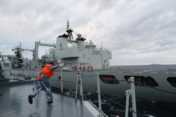 PLA navy officers draw their ships together in close formation during a beach landing drill on Monday. FENG YONGBIN/CHINA DAILY