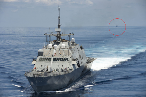 File photo of Chinese Navy fleet (front) keeps eye on U.S. fleet (circled) in South China Sea. File photo of Chinese Navy fleet (front) keeps eye on U.S. fleet (circled) in South China Sea.