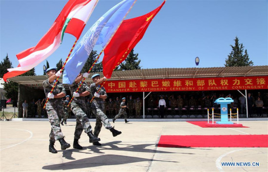 Three flag-bearers parade past the rostrum during the 15th CHINBATT Transfer of Authority (rotation) ceremony in the south Lebanese village of Hinnieh by the port city of Tyre, on May 22, 2017. (Xinhua/Li Liangyong) Three flag-bearers parade past the rostrum during the 15th CHINBATT Transfer of Authority (rotation) ceremony in the south Lebanese village of Hinnieh by the port city of Tyre, on May 22, 2017. (Xinhua/Li Liangyong)