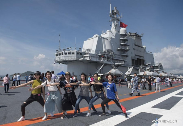 Visitors pose for photos on the flight deck of the Liaoning in Hong Kong, July 9, 2017. (Photo/Xinhua)