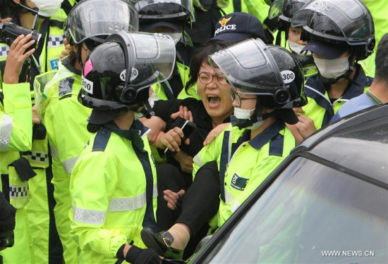 A protester clashes with the police during a demonstration against the Terminal High Altitude Area Defense (THAAD) in Seongju, South Korea, on Sept. 7, 2017. (Xinhua/Yao Qilin) A protester clashes with the police during a demonstration against the Terminal High Altitude Area Defense (THAAD) in Seongju, South Korea, on Sept. 7, 2017. (Xinhua/Yao Qilin)