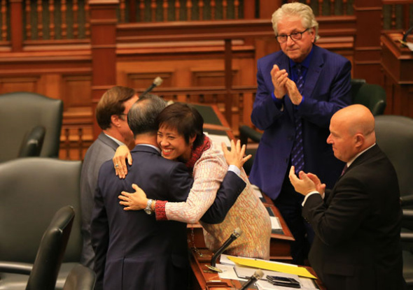 Soo Wong, a member of Canada's Ontario regional parliament, hugs a colleague in celebration after legislators passed a nonbinding motion designating a Nanjing Massacre Commemorative Day. A bill to make the day official awaits a third reading. (ZOU ZHENG/ XINHUA) Soo Wong, a member of Canada's Ontario regional parliament, hugs a colleague in celebration after legislators passed a nonbinding motion designating a Nanjing Massacre Commemorative Day. A bill to make the day official awaits a third reading. (ZOU ZHENG/ XINHUA)