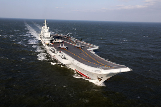 The CNS Liaoning aircraft carrier and a new-generation nuclear-powered ballistic missile submarine participate in the sea parade on Thursday. (ZHANG KAI/HU KAIBING/FOR CHINA DAILY)