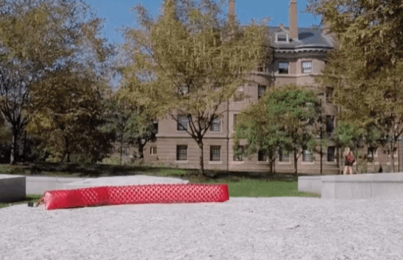 A robotic crawler moving across elevated concrete pavement. (Video/Harvard University)