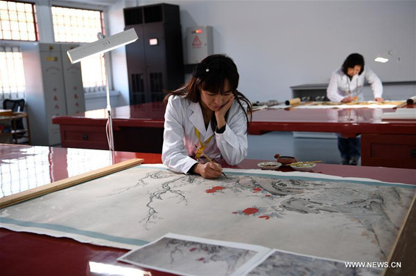 A staff member (front) repairs a painting of the Qing Dynasty at the repair and restoration workshop of the Palace Museum in Beijing, capital of China, Dec. 29, 2016. (Photo/Xinhua) A staff member (front) repairs a painting of the Qing Dynasty at the repair and restoration workshop of the Palace Museum in Beijing, capital of China, Dec. 29, 2016. (Photo/Xinhua)