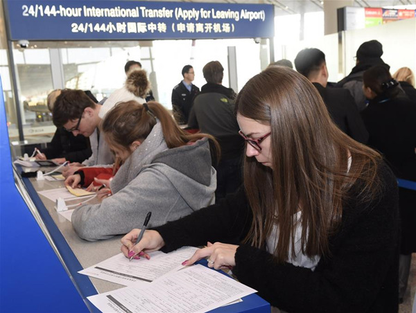 Passengers go through the procedure of 24/144-hour International Transfer at the Terminal 3 at Beijing Capital International Airport in Beijing, capital of China, Dec. 28, 2017. (Xinhua/Luo Xiaoguang)