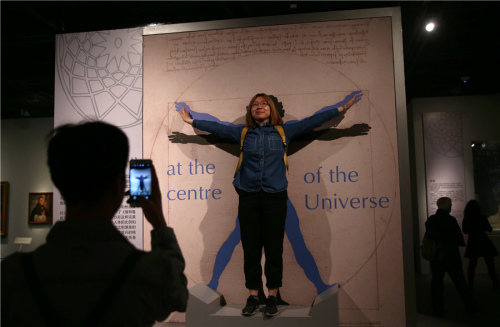 A visitor poses in front of a replica of Vitruvian Man by Leonardo da Vinci at Art, Culture and Daily Life in Renaissance Italy, an exhibition at the Capital Musuem in Beijing through June 22. (Photo by Zou Hong/China Daily) A visitor poses in front of a replica of Vitruvian Man by Leonardo da Vinci at Art, Culture and Daily Life in Renaissance Italy, an exhibition at the Capital Musuem in Beijing through June 22. (Photo by Zou Hong/China Daily)