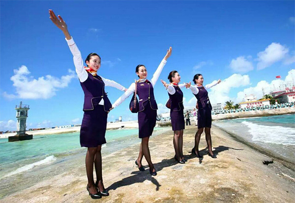 Stewardesses stretch their arms to the sky while celebrating the successful test flights of two Chinese commercial airliners on Jan 6 at a newly built airfield in the Nansha Islands in the South China Sea. (Photo/Xinhua) Stewardesses stretch their arms to the sky while celebrating the successful test flights of two Chinese commercial airliners on Jan 6 at a newly built airfield in the Nansha Islands in the South China Sea. (Photo/Xinhua)