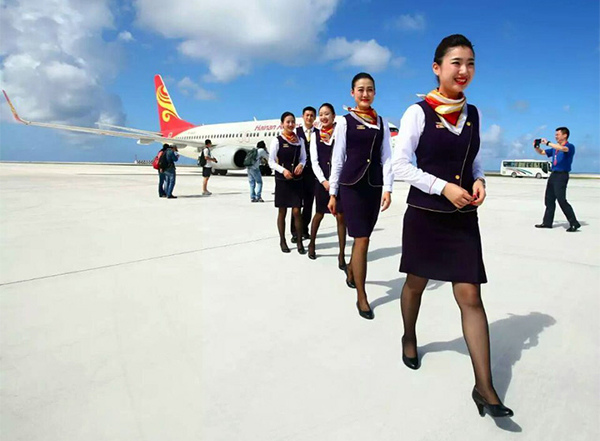 Stewardesses walk out of a Chinese aircraft that landed on the newly constructed runway at Yongshu Jiao in China's Nansha Islands during a test flight on Jan 6. (Photo/Xinhua) Stewardesses walk out of a Chinese aircraft that landed on the newly constructed runway at Yongshu Jiao in China's Nansha Islands during a test flight on Jan 6. (Photo/Xinhua)