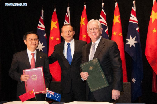 China's Commerce Minister Gao Hucheng (L) and Australia's Trade Minister Andrew Robb (R) pose for photos with Australian Prime Minister Tony Abbott after signing the China-Australia Free Trade Agreement at the National Gallery in Canberra June 17, 2015. (Photo: Xinhua/Justin Qian) China's Commerce Minister Gao Hucheng (L) and Australia's Trade Minister Andrew Robb (R) pose for photos with Australian Prime Minister Tony Abbott after signing the China-Australia Free Trade Agreement at the National Gallery in Canberra June 17, 2015. (Photo: Xinhua/Justin Qian)