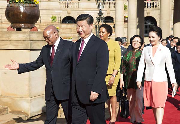 President Xi is warmly welcomed by his South African counterpart Jacob Zuma before their talks in Pretoria, capital of South Africa, on Wednesday. (Photo/Xinhua) President Xi is warmly welcomed by his South African counterpart Jacob Zuma before their talks in Pretoria, capital of South Africa, on Wednesday. (Photo/Xinhua)