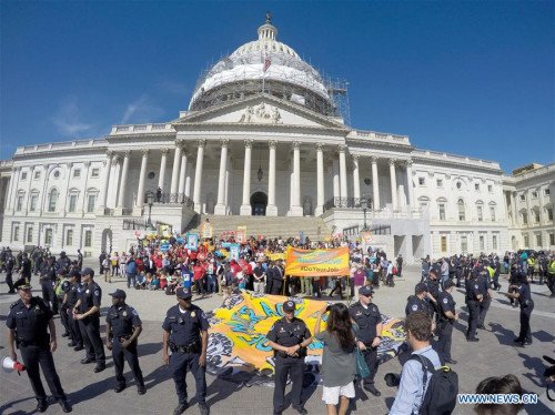 U.S. Capitol Police surround protestors who volunteer to be arrested during a demonstration against Money Politics on Capitol Hill in Washington D.C., the United States, on April 18, 2016. Few hundreds of protestors were arrested, according to demonstration organizers.(Photo: Xinhua/Yin Bogu) U.S. Capitol Police surround protestors who volunteer to be arrested during a demonstration against Money Politics on Capitol Hill in Washington D.C., the United States, on April 18, 2016. Few hundreds of protestors were arrested, according to demonstration organizers.(Photo: Xinhua/Yin Bogu)