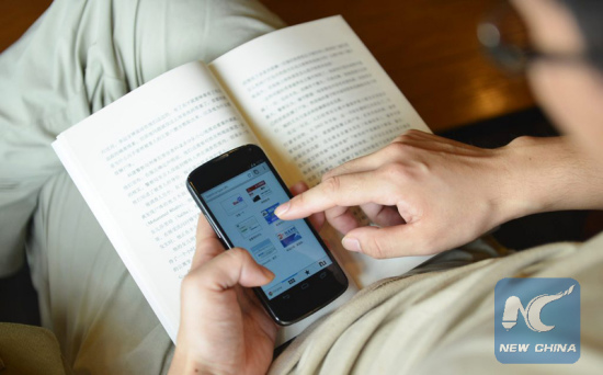 A man browses the Internet on his smartphone, in Hangzhou, east China's Zhejiang Province, July 21, 2014. (Xinhua file photo) A man browses the Internet on his smartphone, in Hangzhou, east China's Zhejiang Province, July 21, 2014. (Xinhua file photo)