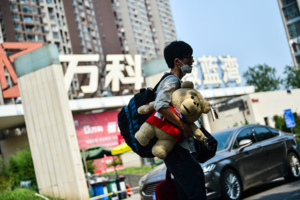 A man walks out of a China Vanke development in Tianjin. (Photo/China Daily) A man walks out of a China Vanke development in Tianjin. (Photo/China Daily)