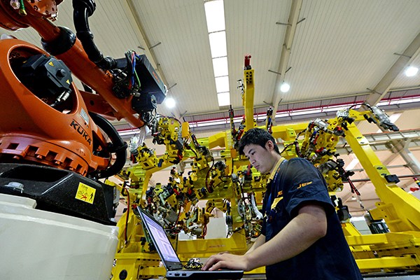 A technician writes the program for a robot bound for export in Hefei, capital of Anhui province. (Photo provided to China Daily) A technician writes the program for a robot bound for export in Hefei, capital of Anhui province. (Photo provided to China Daily)