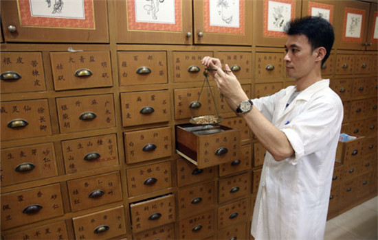 A clerk weighs traditional Chinese medicine in a Tongrentang pharmacy in Kuala Lumpur, Malaysia, in November, 2013. (Photo/China Daily) A clerk weighs traditional Chinese medicine in a Tongrentang pharmacy in Kuala Lumpur, Malaysia, in November, 2013. (Photo/China Daily)