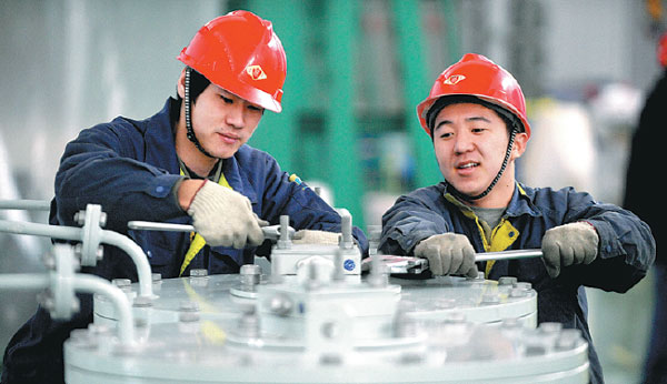 Workers from TBEA Shenyang Transformer Group Co assemble equipment in a plant in Shenyang, Liaoning province. (Photo by Zhang Wenkui/For China Daily) Workers from TBEA Shenyang Transformer Group Co assemble equipment in a plant in Shenyang, Liaoning province. (Photo by Zhang Wenkui/For China Daily)