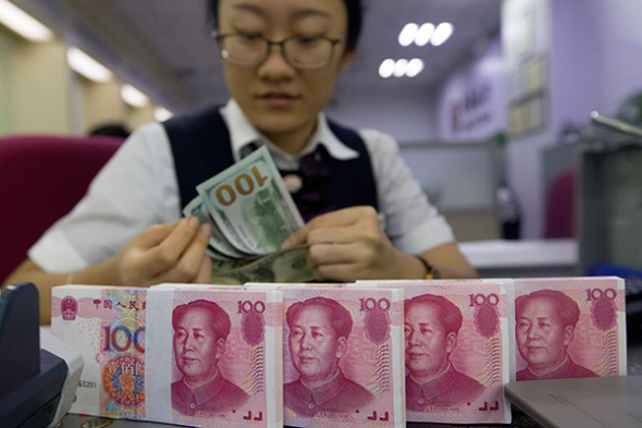 A clerk counts money at a bank in Taiyuan, North China's Shanxi province. (Photo/China News Service) A clerk counts money at a bank in Taiyuan, North China's Shanxi province. (Photo/China News Service)