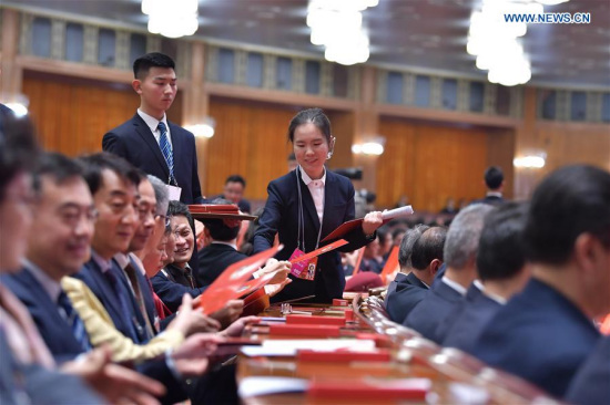 A staff member distributes ballots at the fourth plenary meeting of the first session of the 13th National Committee of the Chinese People's Political Consultative Conference (CPPCC) at the Great Hall of the People in Beijing, capital of China, March 14, 2018 (Xinhua/Li Tao) A staff member distributes ballots at the fourth plenary meeting of the first session of the 13th National Committee of the Chinese People's Political Consultative Conference (CPPCC) at the Great Hall of the People in Beijing, capital of China, March 14, 2018 (Xinhua/Li Tao)